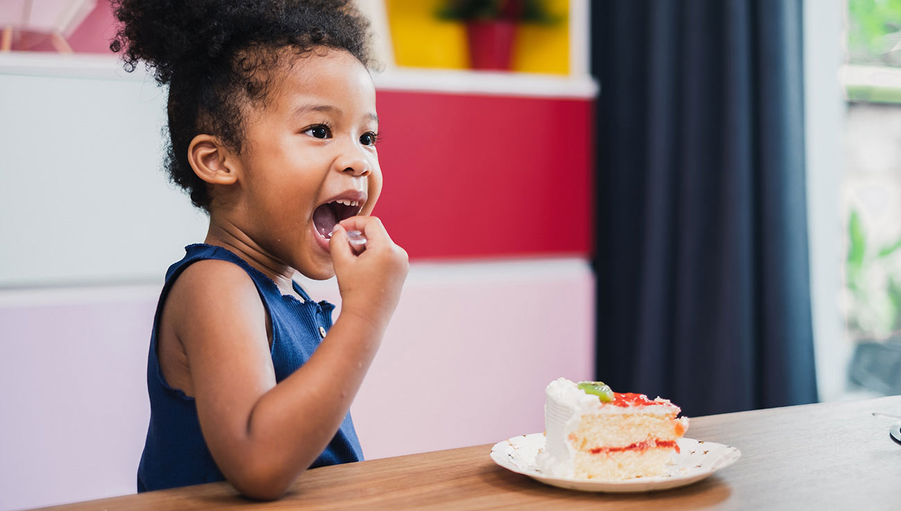 Kid Having Fun Eating Cake